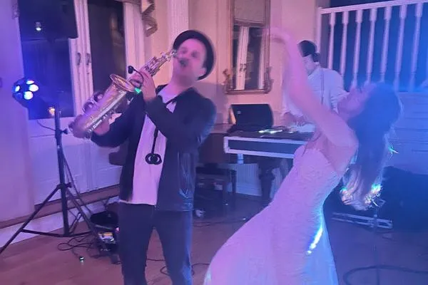 Saxofonist spiller på dansegulvet, mens gæsterne danser